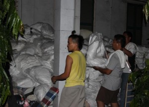 Bukas Palad Volunteers unload sheets in Cebu port.