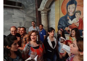 Cardinal Philippe Barbarin of Lyons sings with Iraqi Christians in a church in Kirkuk on 31 July.
