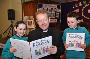 Archbishop Eamon Martin reads to Erin, 11, and Eoin, 11, Primary 7 pupils at St Patrick's Primary School Armagh at the Launch of "Dear Pope Francis". Photo: LiamMcArdle.com