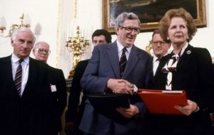 Prime Minister Margaret Thatcher and Taoiseach Garret Fitzgerald shake hands after signing Anglo-Irish Agreement. Peter Barry is on left.