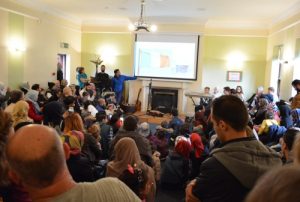 Syrians and Irish watch presentation on Ireland at Intercultural party.