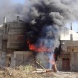 Syria war, burning building in Homs